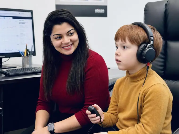 Boy wearing headphones during a hearing test with a Simply Hearing clinician on the Gold Coast